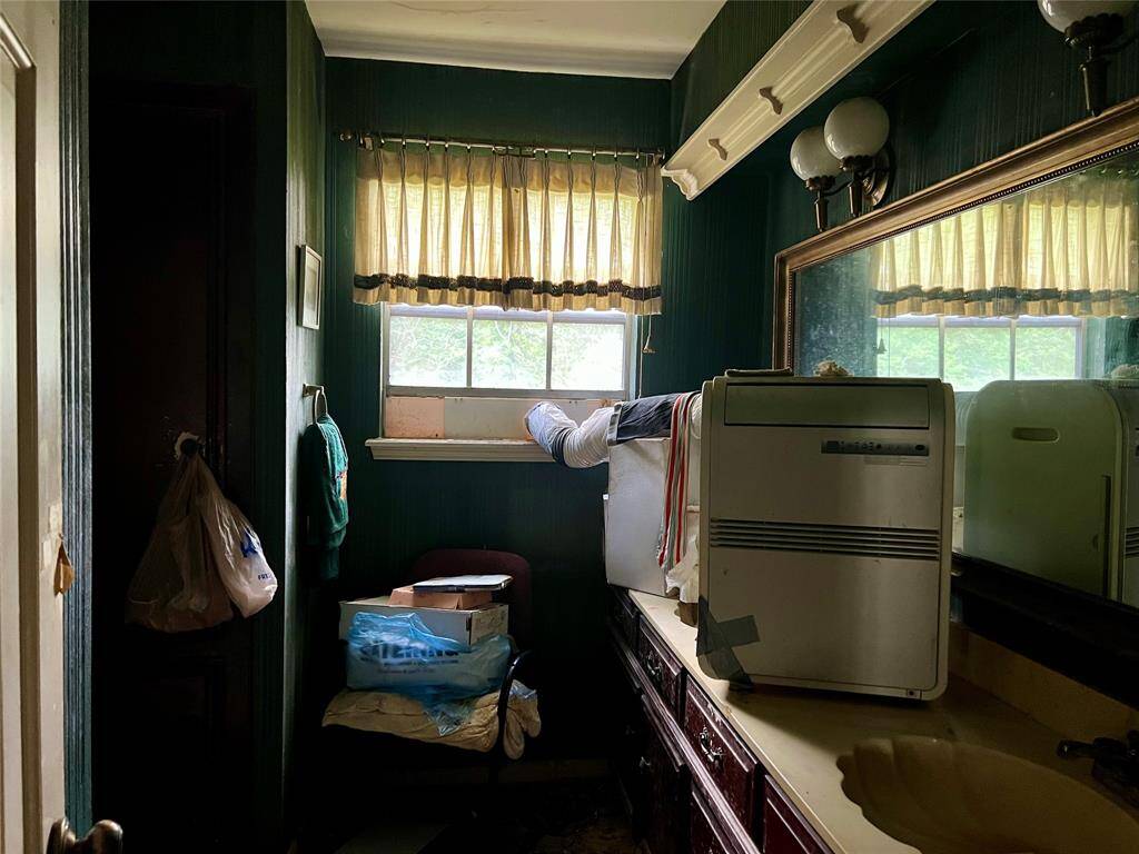 Double sinks in primary bath. Windows look out to front upper porch.