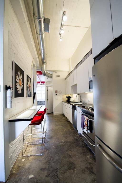 VIEW OF KITCHEN AND UNDER LIGHT BAR