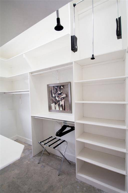 MASTER WALK IN CLOSER FEATURES AN ABUNDANCE OF HANGING SPACE AND SHELVING FLOR CLOTHING, SHOES, OR HANDBAGS