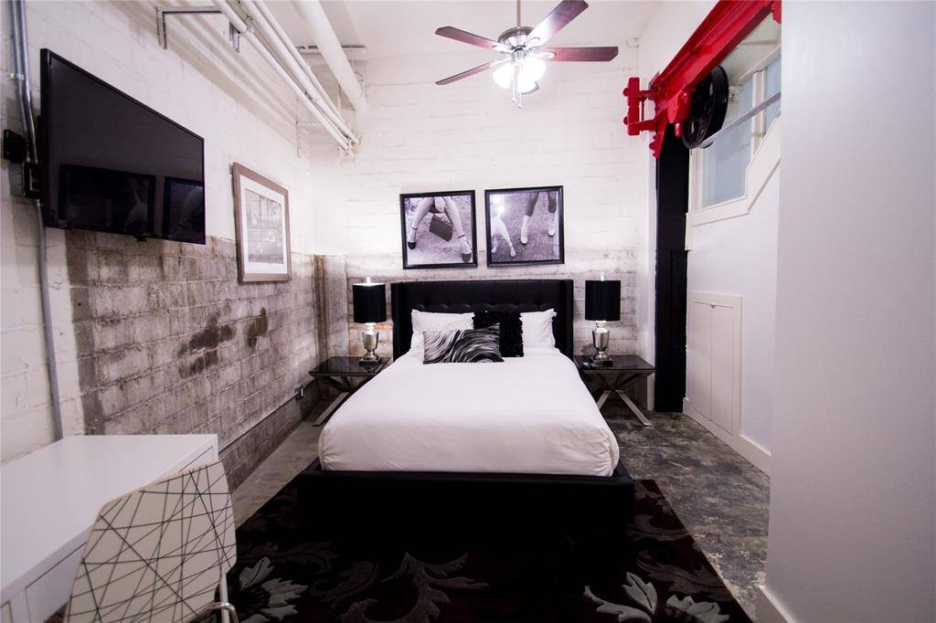 2ND BEDROOM FEATURES EXPOSED BRICK WALLS AND EN-SUITE BATH