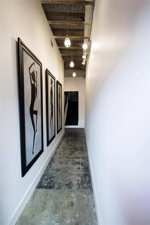 GALLERY STYLE ENTRY WITH RAW STEEL EXPOSED BEAMS SHOWING AND ULTRA CONTEMPORARY LIGHTING