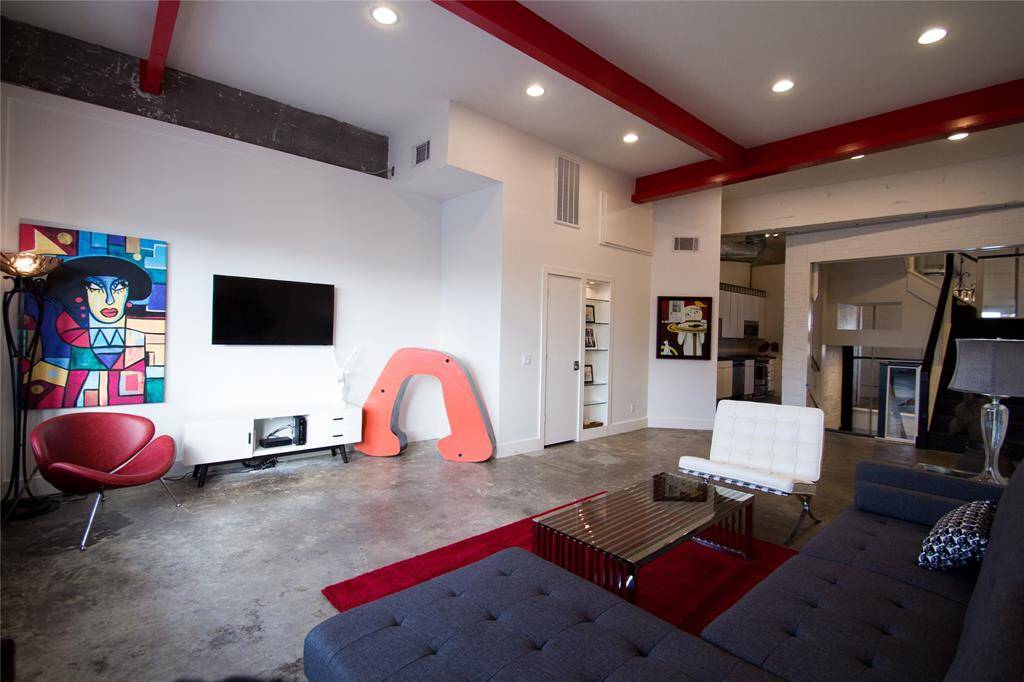 SECOND FLOOR LIVING AREA WITH EXPOSED METAL BEAMS. FEATURES KITCHEN, BREAKFAST ROOM, HALF BATH AND STORAGE CLOSET.