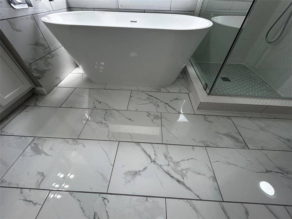 Soaking tub with beautiful tile flooring