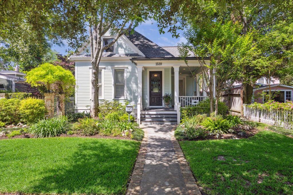 The facade is pure turn-of-the-century elegance- original cypress wood siding and trim, which dominate the front and side views of the house, speak to early 20th century craftsmanship.  Alley access reveals a spacious garage with newly installed Elfa storage and extra parking.
