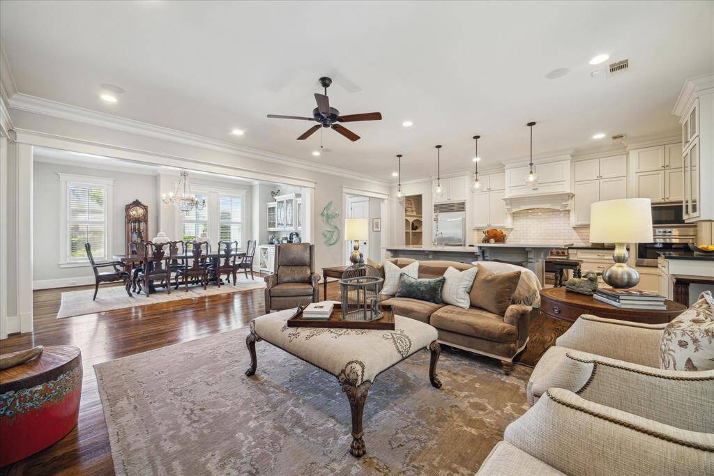Spacious open-concept layout connects the living room, dining area, and kitchen with a smooth, functional flow. The kitchen offers a large island with seating, while the dining room and living area provide ample space for entertaining and everyday living. Generous windows bring in natural light, and the layout allows for easy movement between each space.
