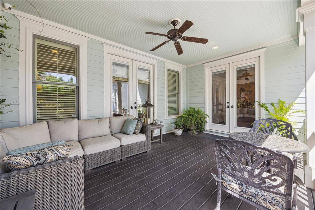 A true extension of the interior living space, this covered porch offers a seamless transition from indoors to out. French doors lead directly from the primary suite.