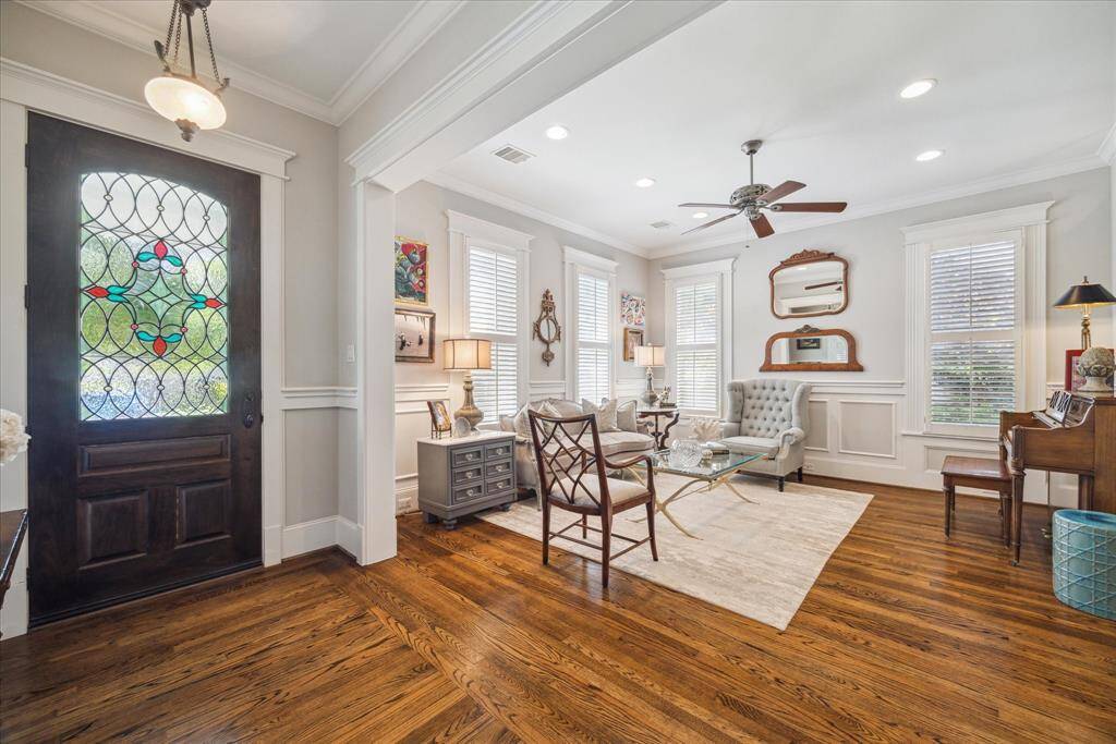 The moment you step inside, all eyes are drawn to the front door - a show-stopping piece of craftsmanship that anchors the home’s historic narrative. The leaded glass inset creates subtle prisms of light, casting a gentle glow into the foyer and setting a tone of refined warmth.