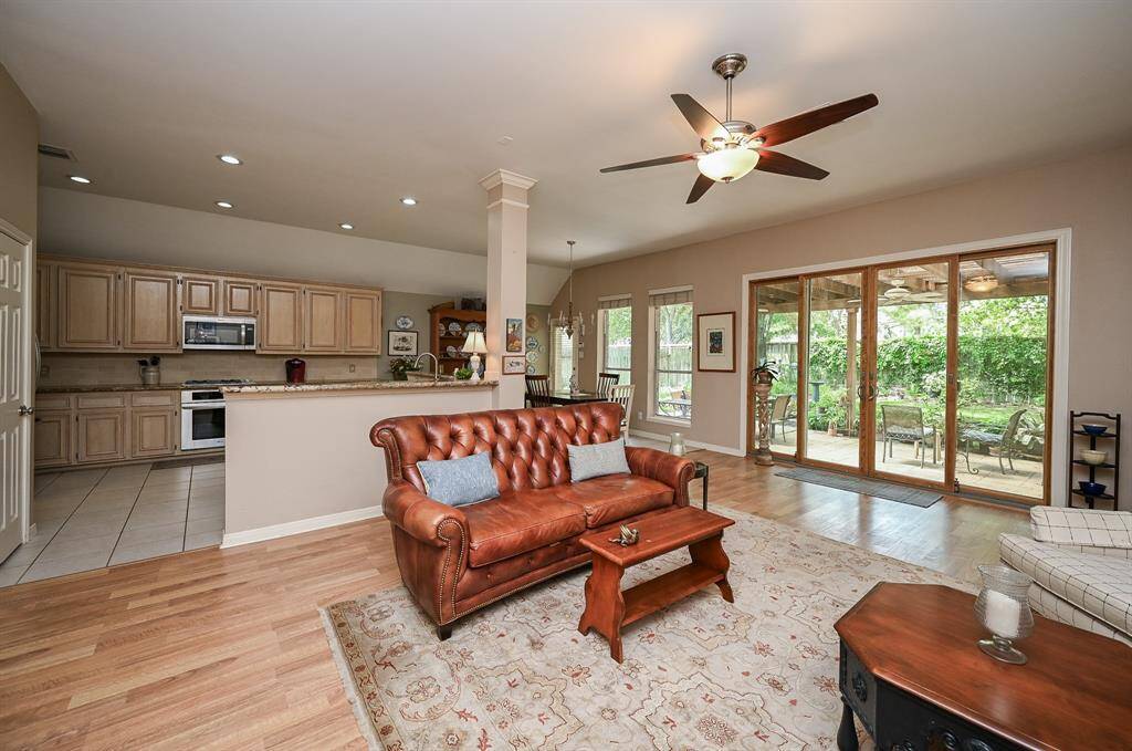 These doors flood the room with light and offer a picturesque view of the lush, landscaped yard and covered patio—perfect for enjoying nature from the comfort of your home.