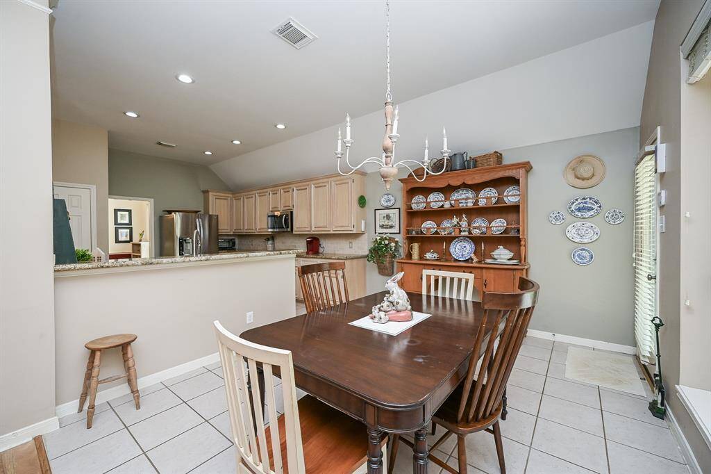 The dining area is ideally situated between the kitchen and living space, offering open sightlines and a cohesive layout perfect for entertaining.