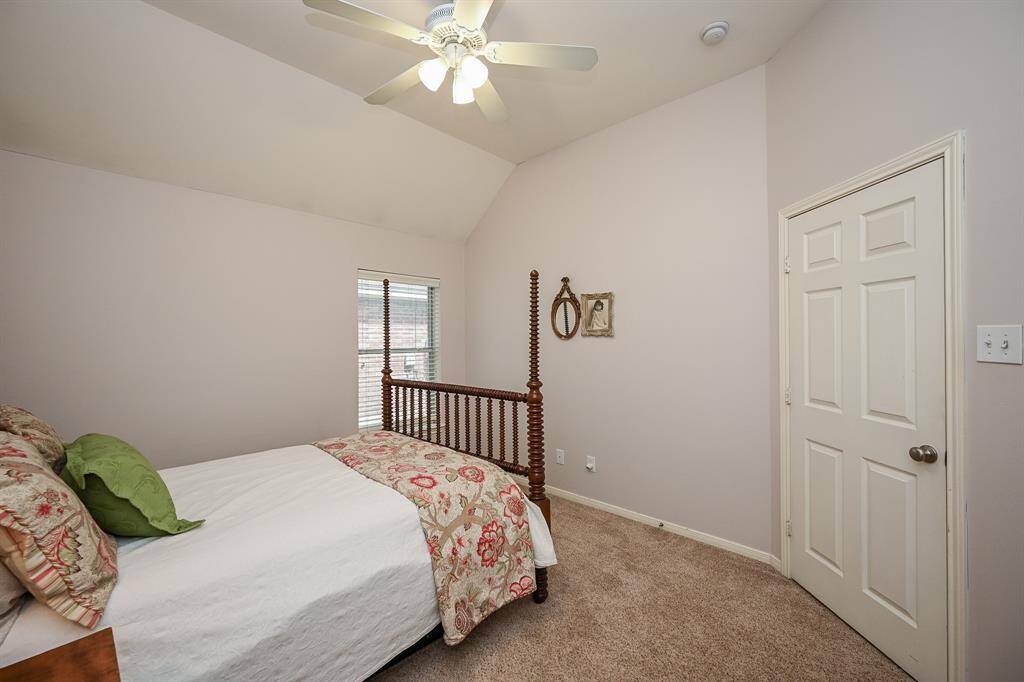 This inviting bedroom offers a simple layout and soft carpeting