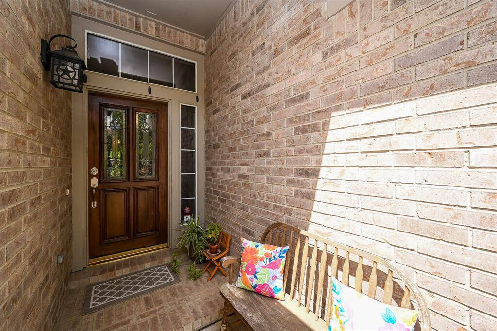 Inviting front porch entry with a recessed doorway and space for seating, offering a warm first impression.