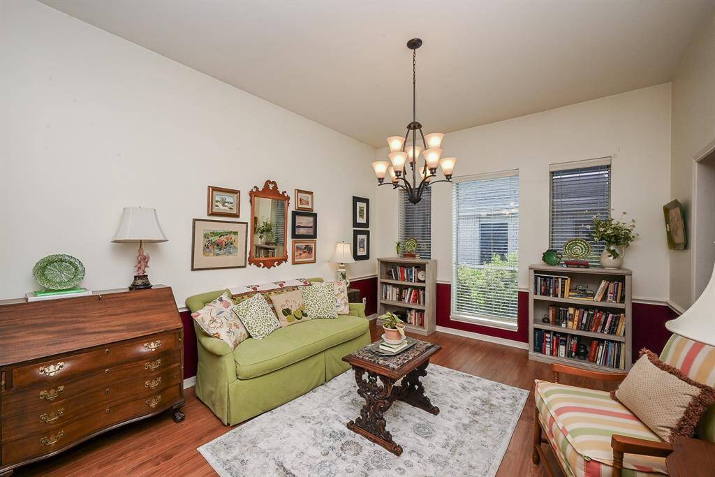 This versatile front room features tall ceilings and abundant natural light, ideal for entertaining or relaxing.