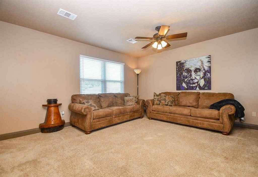 A large game room with plenty of space for activities or relaxing. The floorplan is open to downstairs and allows lots of natural light.