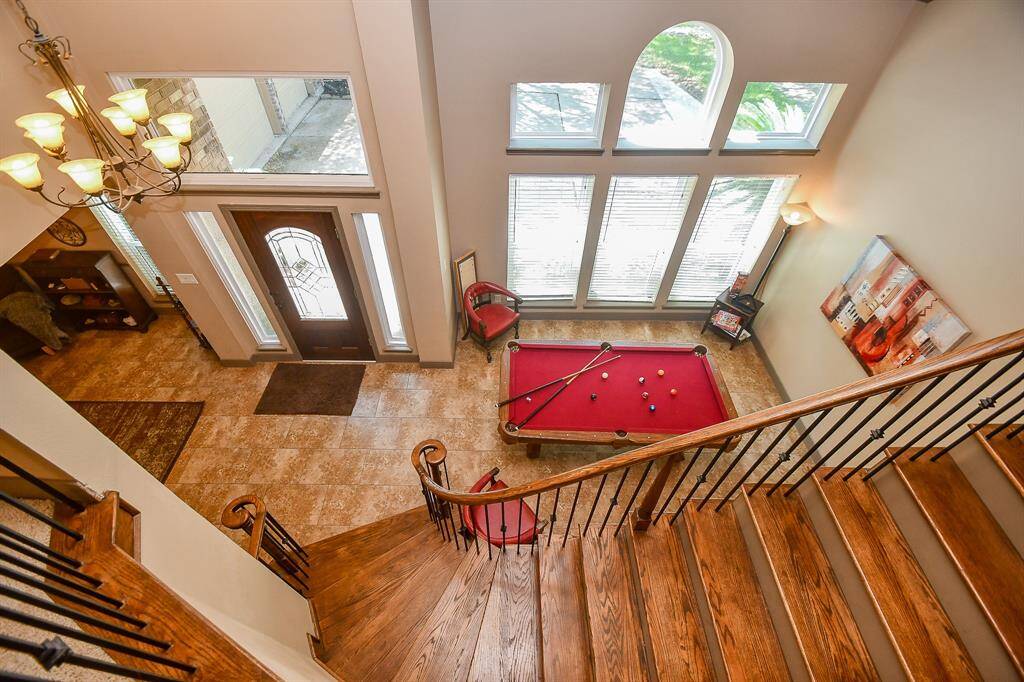 This inviting home features a spacious entryway with large windows all amid a grand wooden staircase. Lots of natural light for entertaining or relaxing!