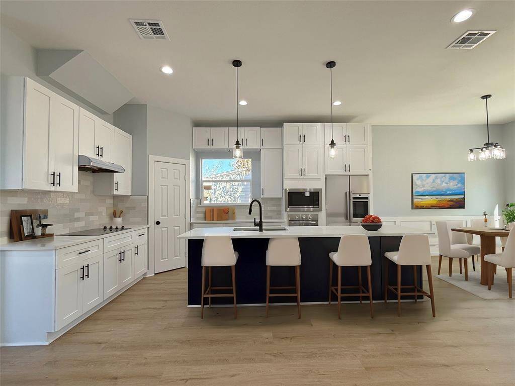 A stunning kitchen designed to impress, featuring a spacious central island perfect for gatherings and meal prep. Outfitted with top-of-the-line materials, from sleek countertops to modern cabinetry, and equipped with high-end appliances. A space that seamlessly blends functionality and style, ideal for the home chef.Staged