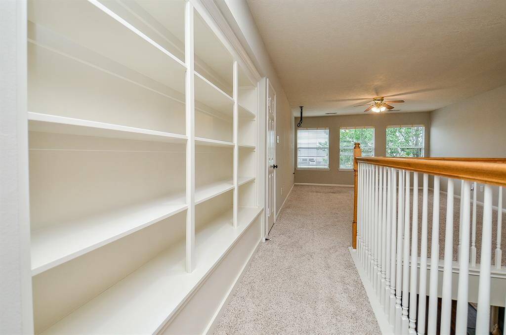 Entering the Spacious upstair game room with built-in shelves.