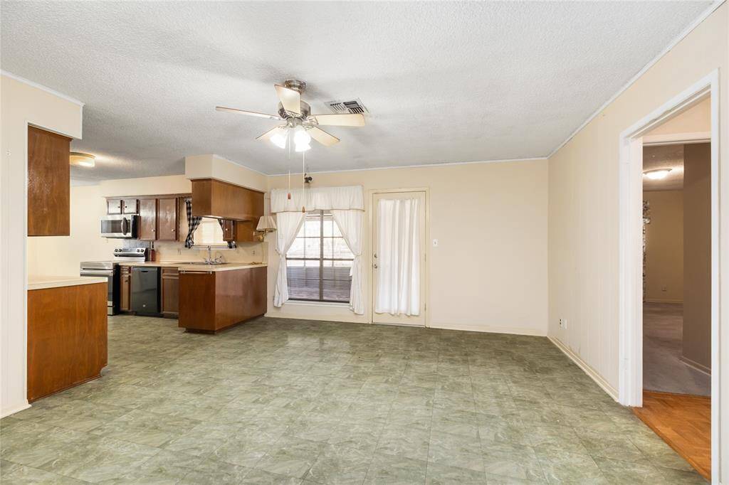 A spacious open-plan dining area and kitchen creates a bright and welcoming atmosphere and provides ample space for gatherings, meals, and entertaining.