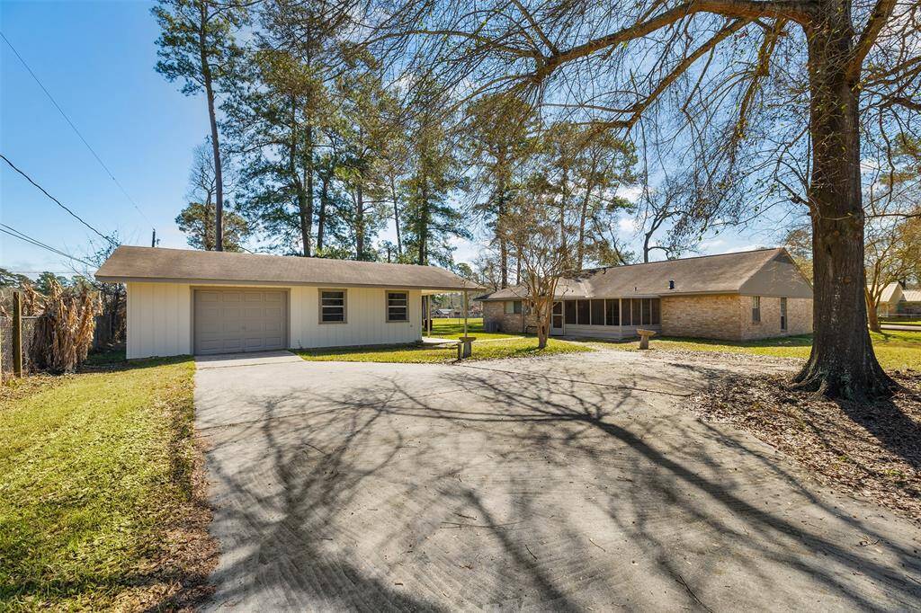 With a detached garage and a brick house nestled among mature trees, this cozy home allows you to feel private tranquility while still providing easy access to local amenities and necessities. The wide driveway, leads to the garage. The home features a covered patio area, great for enjoying morning coffee or evening sunset. The yard is well-maintained, providing a serene, natural setting.