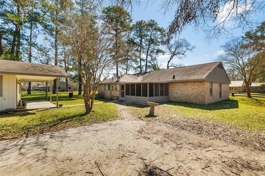 This charming single-story brick home features a spacious screened porch, perfect for relaxing while overlooking the lush, tree-lined yard. The detached 3-car carport provides ample covered parking, while the mature trees offer shade and tranquility, creating an inviting outdoor retreat.