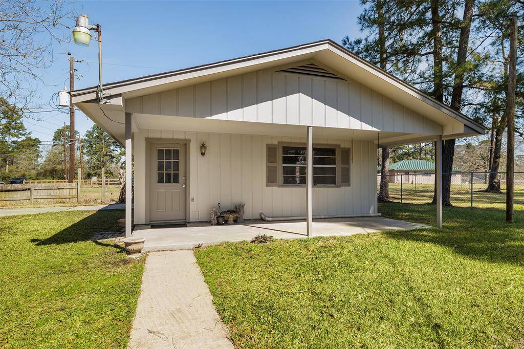 This cozy home features a simple, inviting facade with a covered front porch and a well-maintained lawn, set in a peaceful, tree-lined neighborhood.