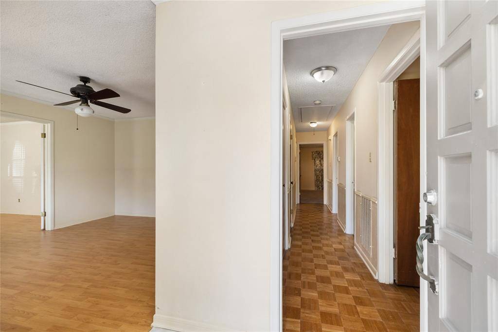 Step into the bright and inviting entryway, which leads into a spacious hallway. The adjacent room enhances the home's open and airy atmosphere.