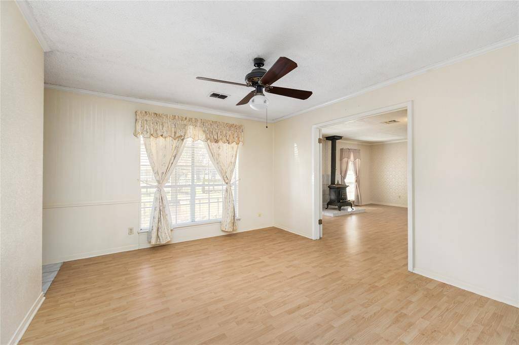 The home is flooded with an abundance of natural light thanks to the large windows, soft-color flooring, and bright walls throughout.