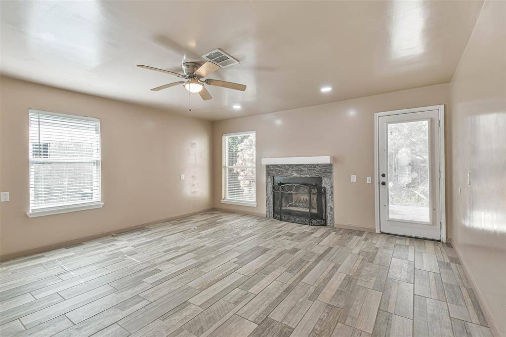 Family room with wood burning fireplace.