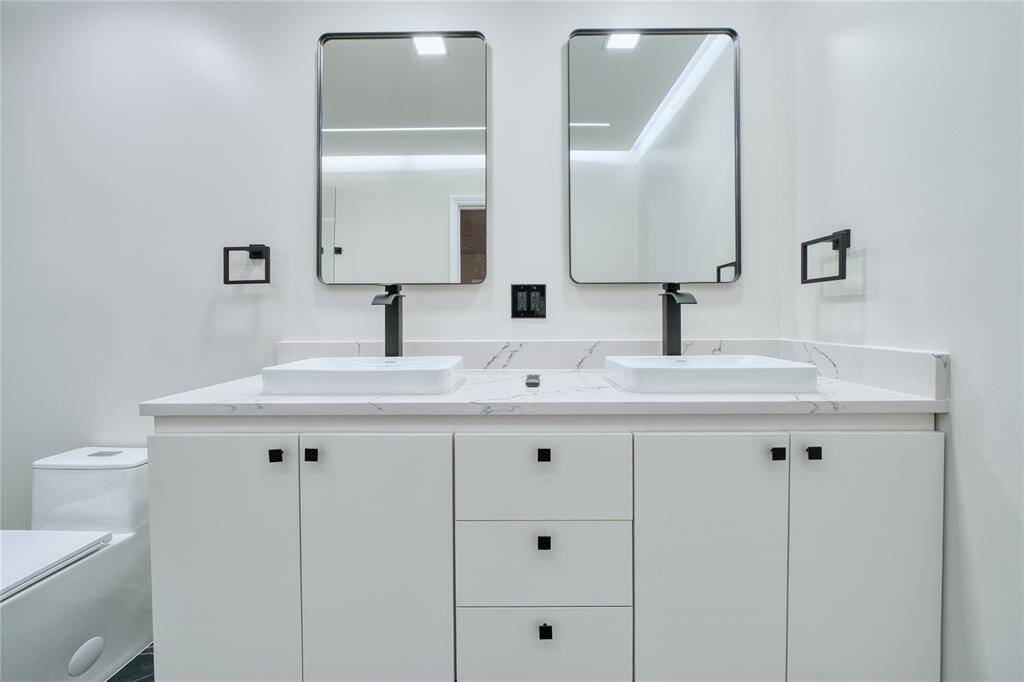 Completed renovated primary bathroom features double sinks and plenty of cabinet space
