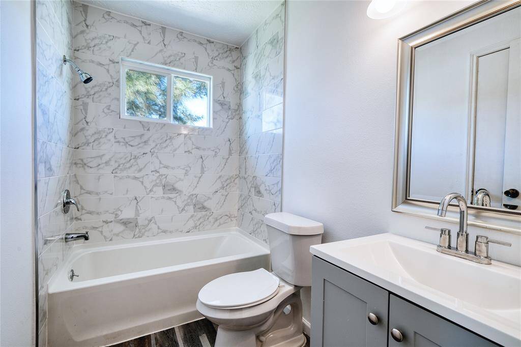 Full bathroom upstairs is a tub/shower combo and has been updated with new gorgeous marble look tile, new vanity and fresh paint.