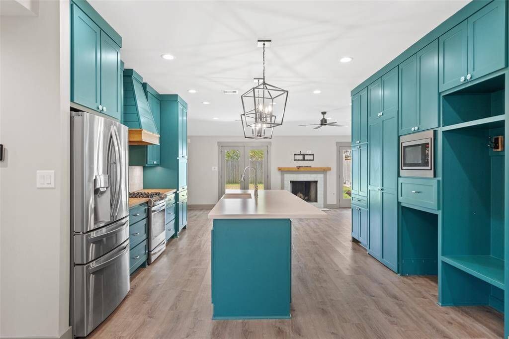 The galley kitchen is a chef's dream with ample storage, stainless steel appliances and a quartz countertop island.
