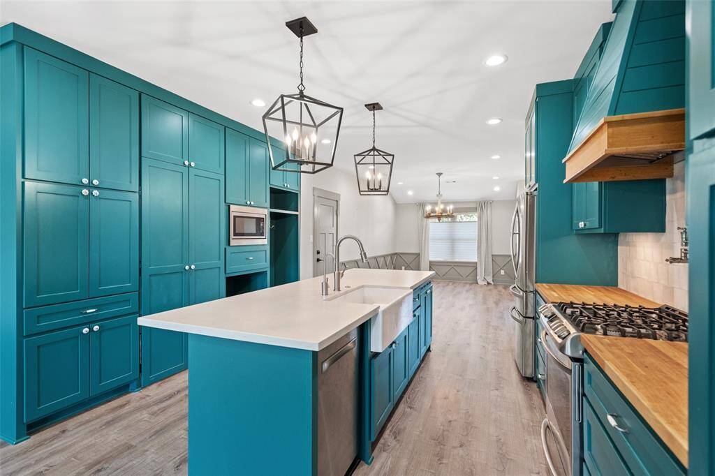 Truly the heart of the home, the kitchen features butcher block counters, pot filler and undermount farmer's sink.