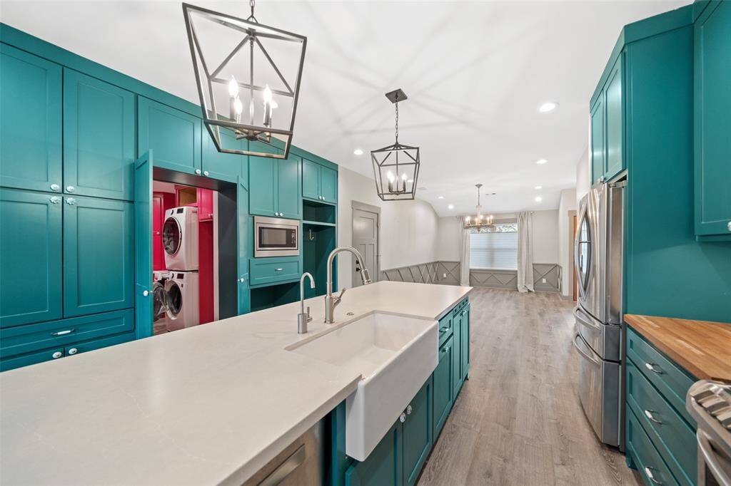 Behind a set of double doors, the kitchen holds a surprise - your oversized laundry room!