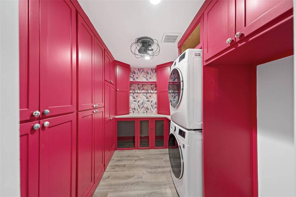 Equipped with a full sized washer a dryer - this laundry room features floor to ceiling cabinetry for additional storage or space for all your kitchen needs.