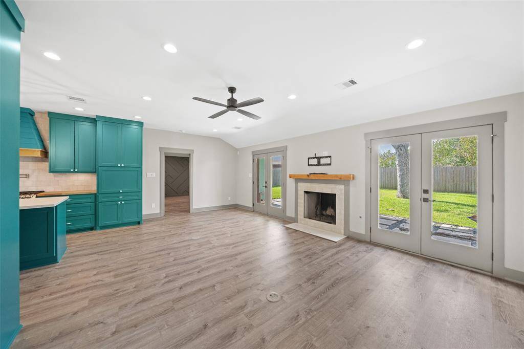 Filled with natural light, the bright family room boasts a central fireplace and double French doors leading to the backyard - perfect for relaxing and entertaining.