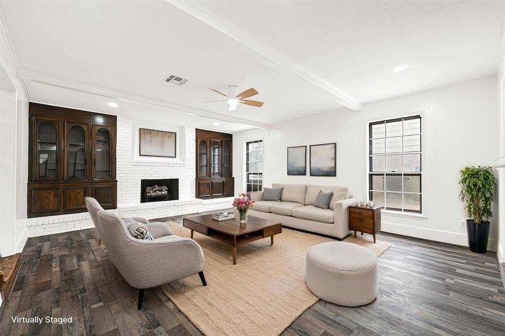 Virtually Staged:The living room features a fireplace, built in cabinetry and tons of natural light.