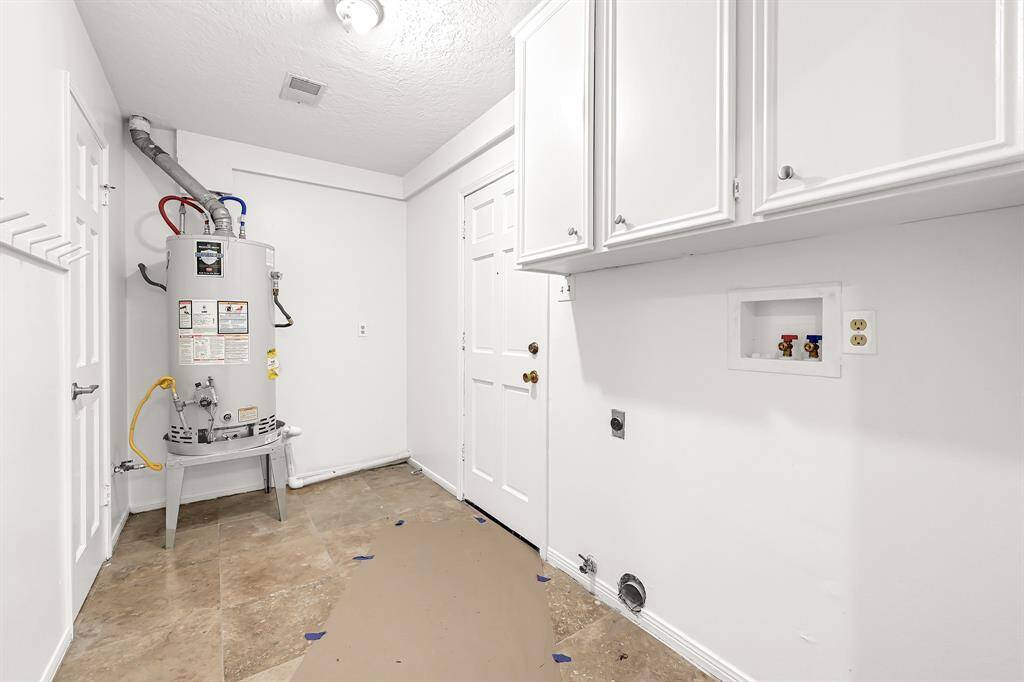 Utility room in house with space for storage.