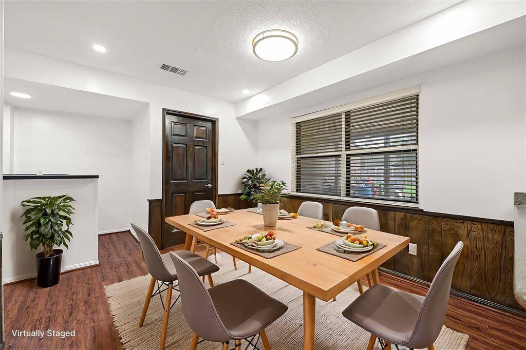 Virtual Staged: View of the formal dining and entrance to the wet bar.