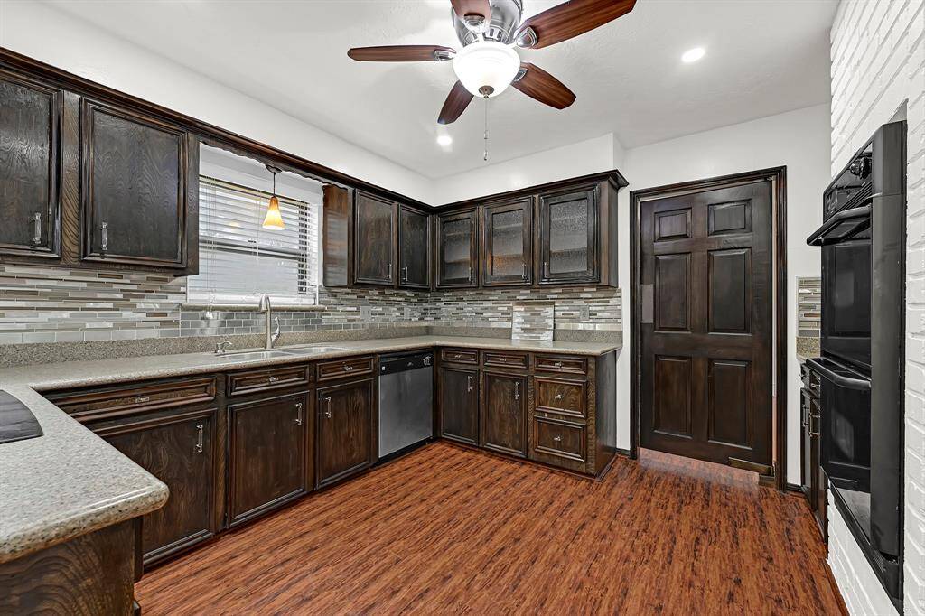 This kitchen features amply cabinentry space, granite counter tops, and even room to add a center island.