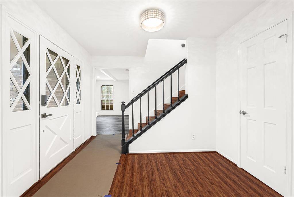 Front entry way with formal living off to the left and a large flex room to the right.