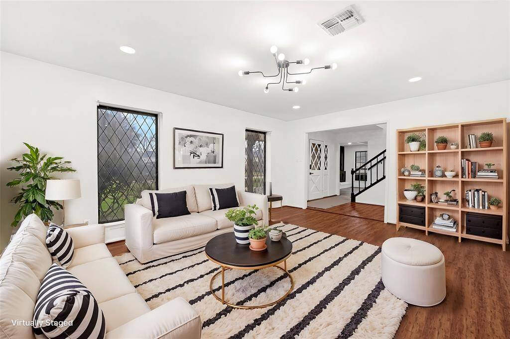 Virtual Staged: Common Area or additional flex room off the front of the home could be used for many purposes.