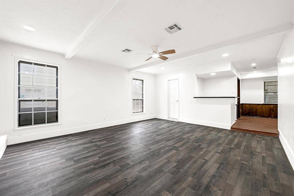 Formal living with a dry bar off the back and access to the formal dining room.