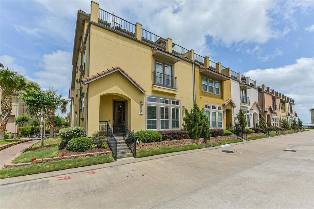 Stunning corner townhome located in a gated and waterfront community