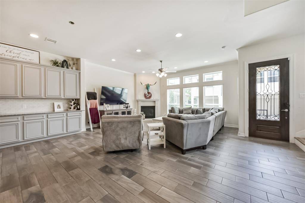 Living room open to the kitchen features a fire place