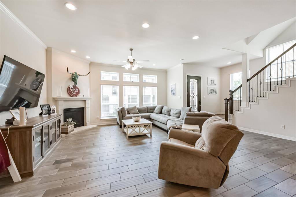 Living room open to the kitchen features a fire place