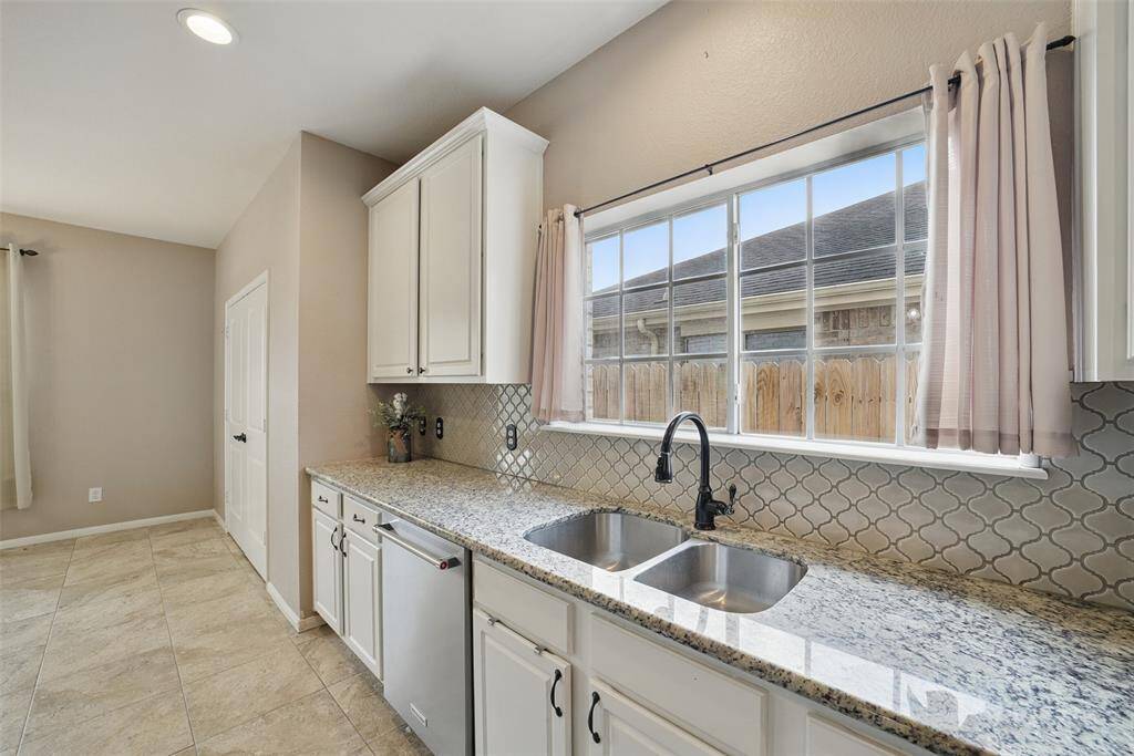 The double doors to the left of the counter open to a large custom pantry.