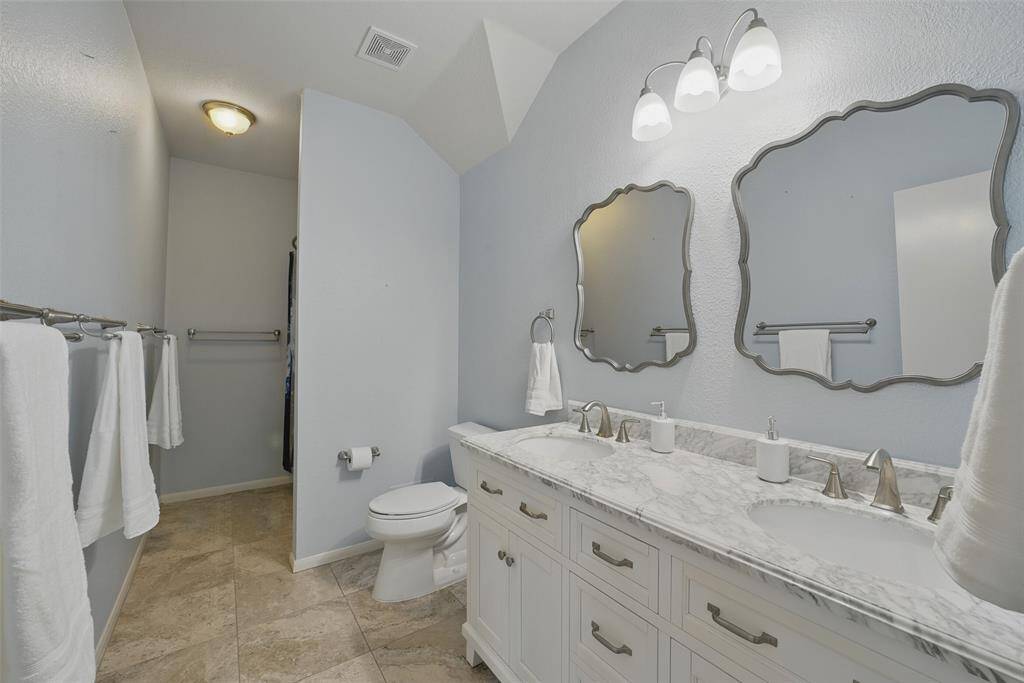 Second floor bathroom with double sinks.