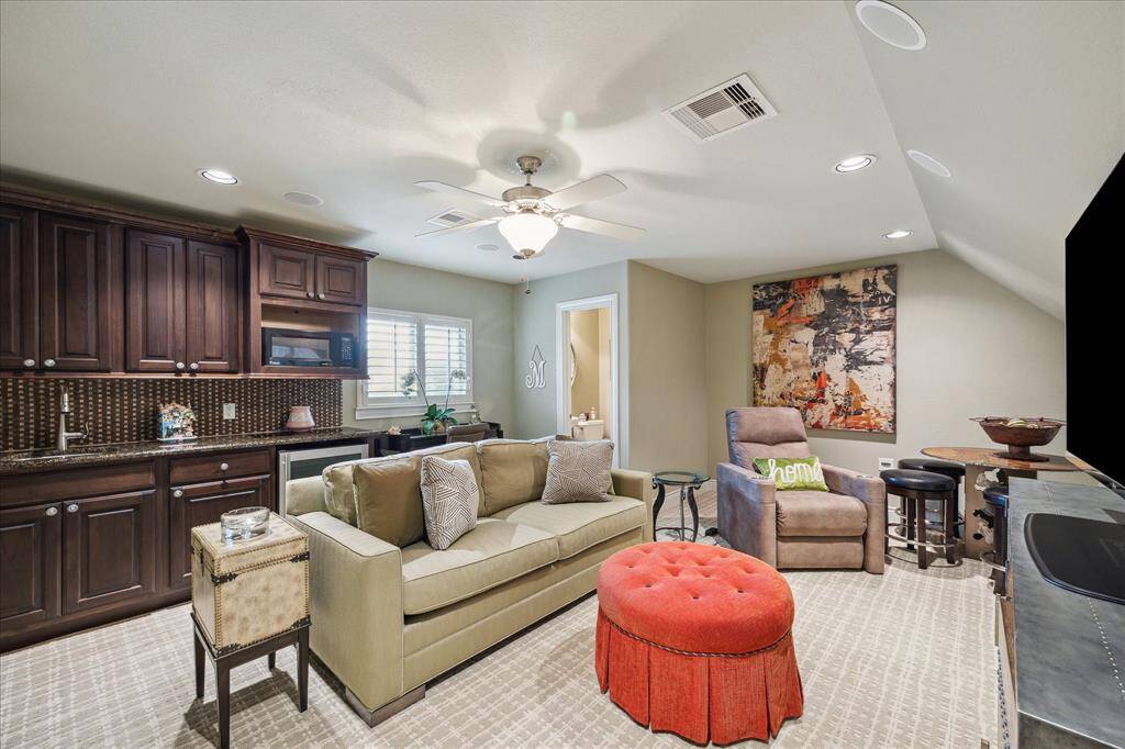 Extremely valuable space upstairs that is currently being used as a theatre room and has a half bath.