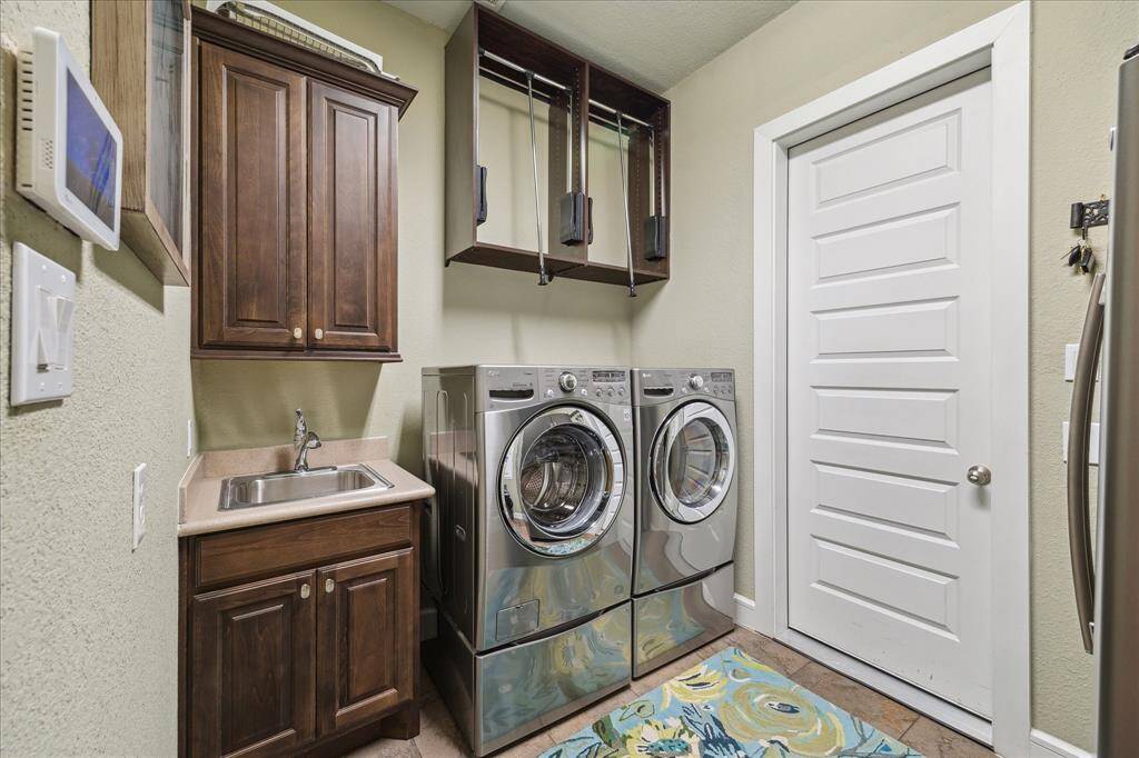 Spacious laundry room leads to the garage.