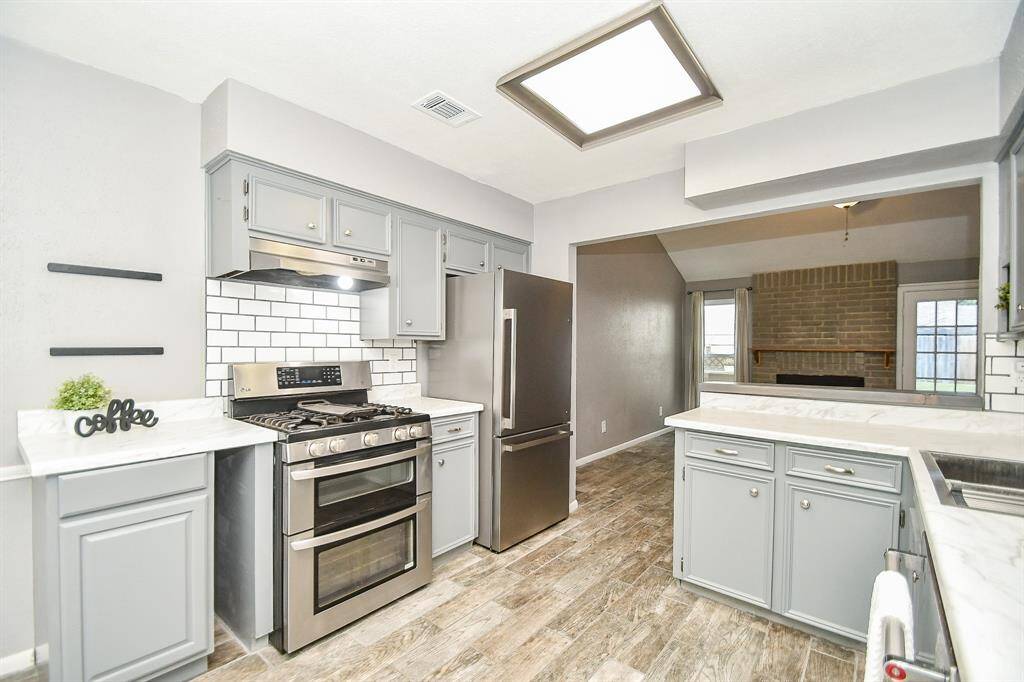 Kitchen offers a counter depth fridge.