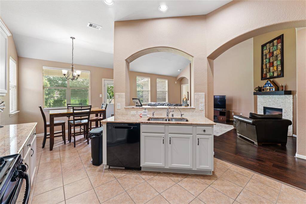 The open floor plan provides a view of the breakfast nook and family room and views of the back yard